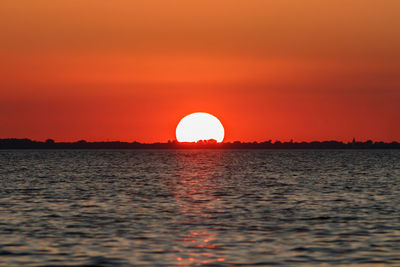 Scenic view of sea against romantic sky at sunset