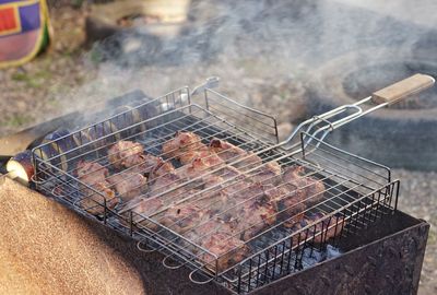 High angle view of meat on barbecue grill