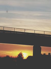 Low angle view of bridge against sky during sunset