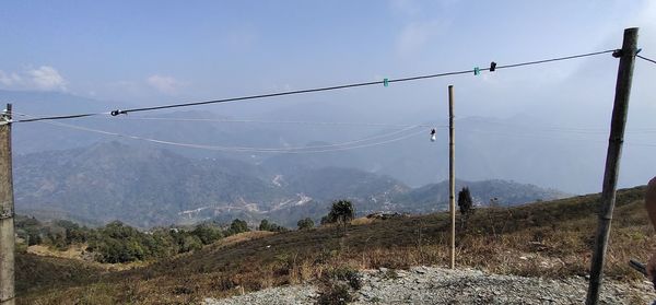 Low angle view of overhead cable car against sky