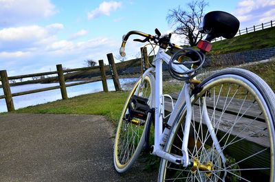 Bicycle on railing against sky