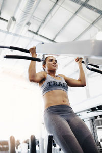 Low angle view of woman exercising at gym