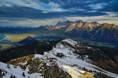 Scenic view of snowcapped mountains against sky during sunset