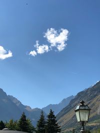 Low angle view of electric lamp against sky