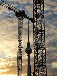 Low angle view of crane against sky