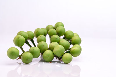 Close-up of grapes over white background