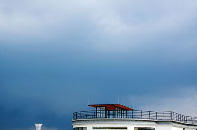 Low angle view of building terrace against cloudy sky