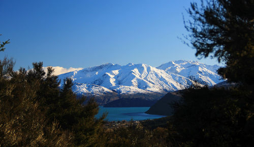 Scenic view of snowcapped mountains against blue sky