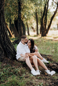 Young couple sitting on land