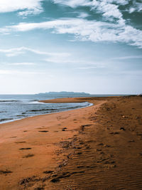 Scenic view of beach against sky which is located in malaysia.