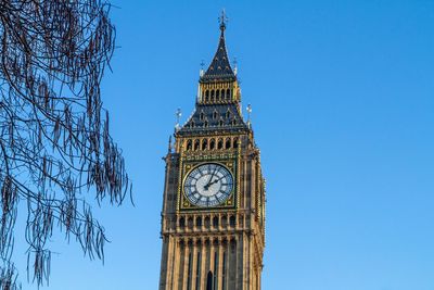 Low angle view of clock tower against sky in city