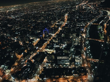 Aerial view of illuminated buildings in city at night