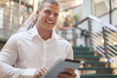 Portrait of smiling young man using mobile phone