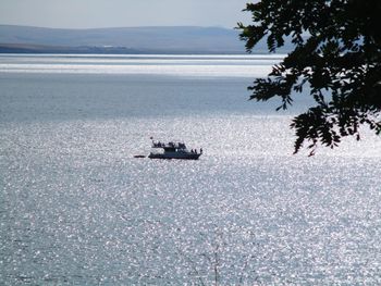 Boat sailing on sea against sky