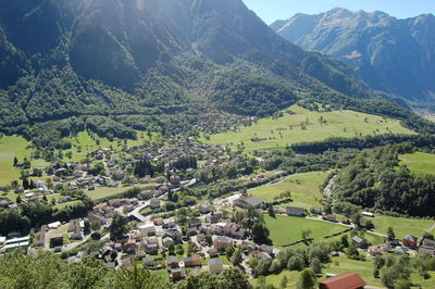 Aerial view of trees and houses against mountains