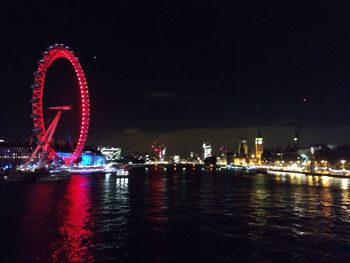 Illuminated ferris wheel at night