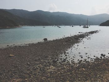 Scenic view of lake and mountains against sky