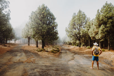 Rear view of woman walking on field