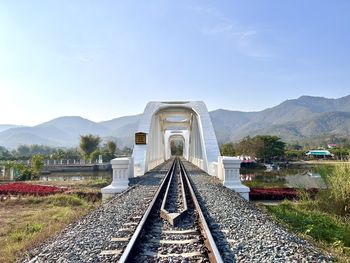 Bridge over mountains against sky