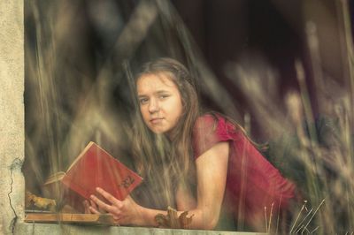 Portrait of girl holding book