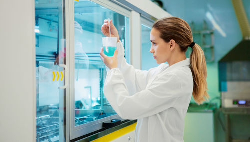 Close-up of young woman working in laboratory