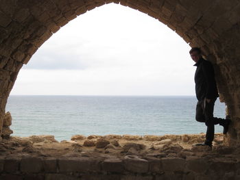 Man standing by sea against sky