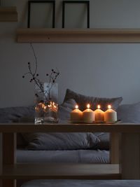 Illuminated lamps on table at home