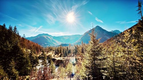 Scenic view of mountains against bright sun