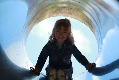 Low angle view of woman standing against sky