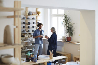 Man and woman talking in art studio