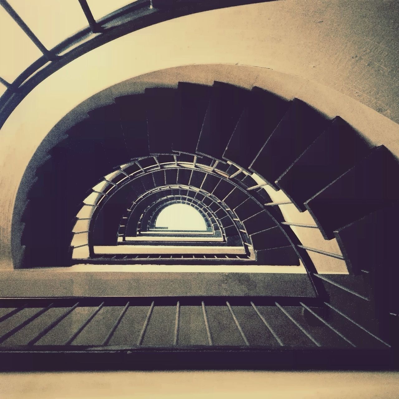 architecture, built structure, steps, steps and staircases, staircase, railing, arch, indoors, low angle view, building exterior, spiral staircase, stairs, spiral, building, pattern, architectural feature, ceiling, directly below, the way forward, diminishing perspective