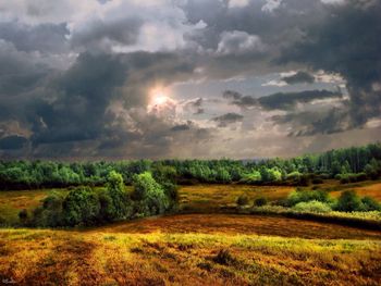 Scenic view of landscape against cloudy sky