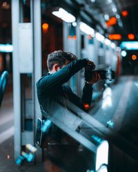 Side view of man photographing