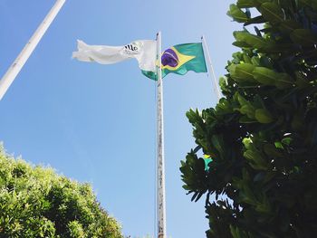 Low angle view of flag against blue sky