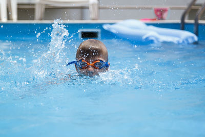 Portrait of boy swimming in pool