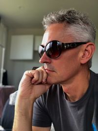 Portrait of man wearing sunglasses at home
