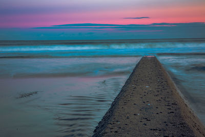 Scenic view of sea against sky at sunset