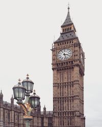 Low angle view of clock tower against sky