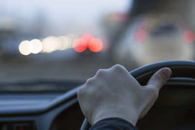 Close-up of hand holding finger against blurred background