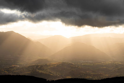 Scenic view of silhouette mountains against sky during sunset