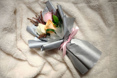 High angle view of rose bouquet on bed