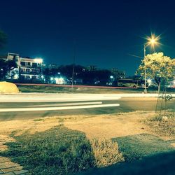 Illuminated street light against blue sky