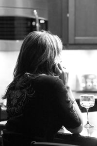 Rear view of woman sitting at restaurant