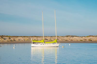 Sailboat on sea against sky