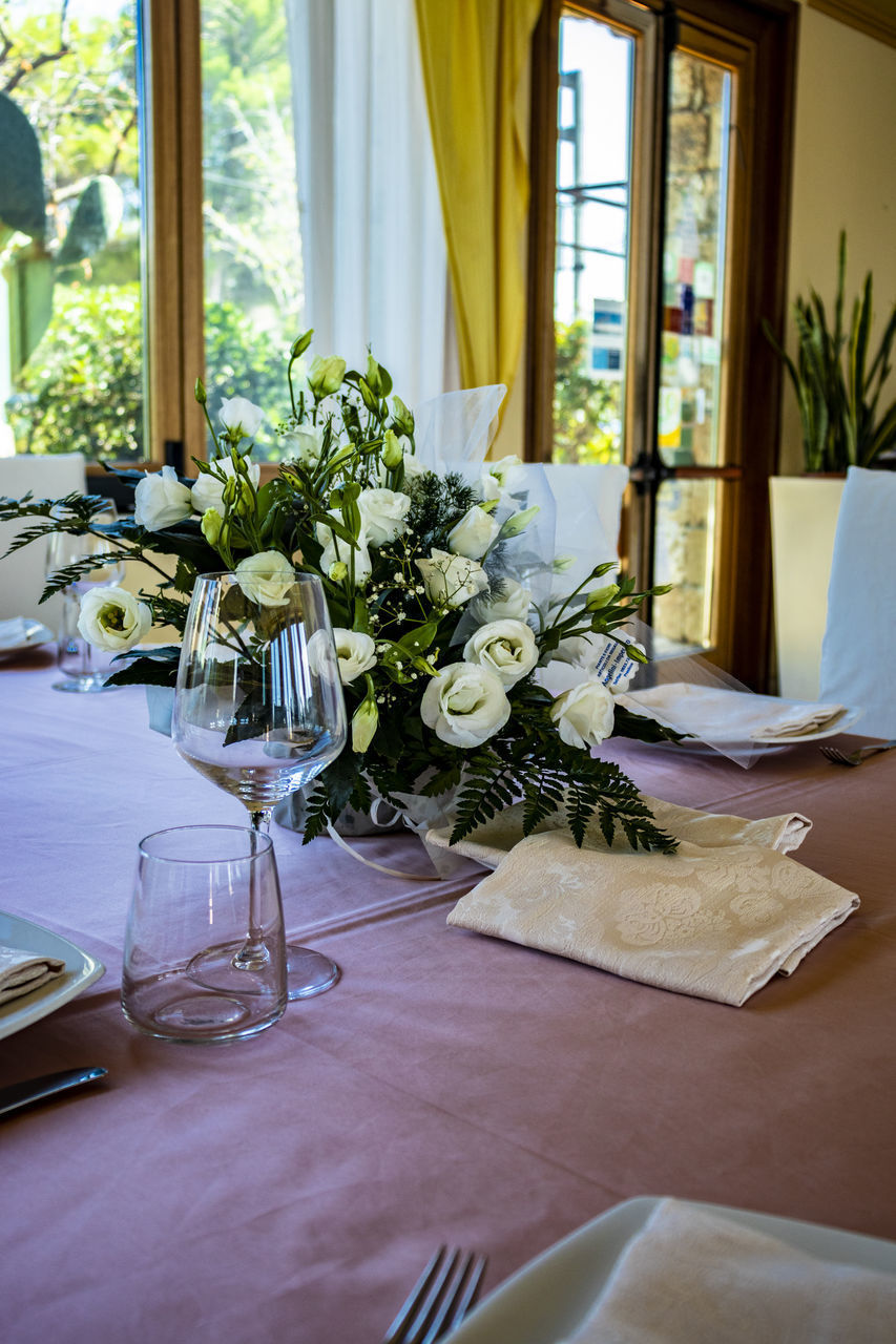 POTTED PLANT ON TABLE BY WINDOW