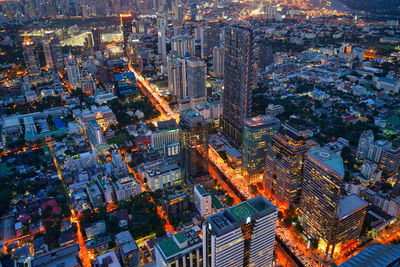 High angle view of illuminated street and buildings at night
