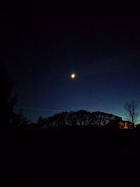 Silhouette landscape against clear sky at night