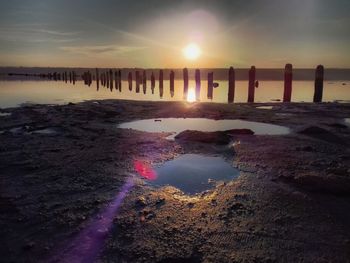 Scenic view of beach against sky during sunset