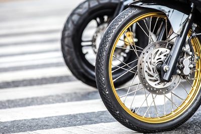 Cropped image of motorcycle on zebra crossing