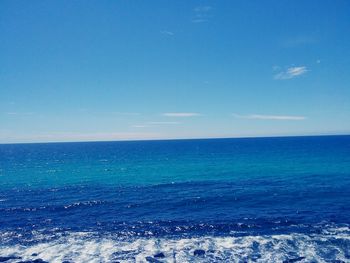 Scenic view of sea against clear blue sky